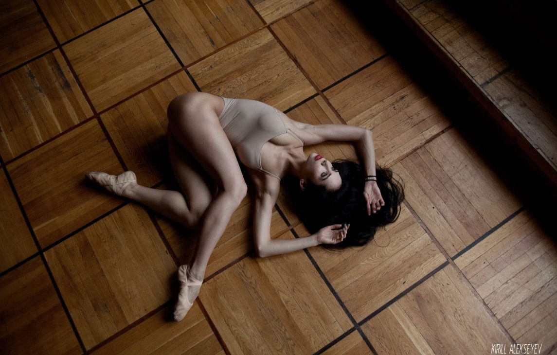 ballerina lying at the ground
