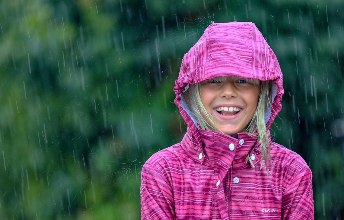 Girl smiling under the rain