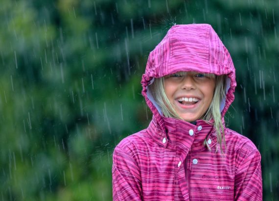 Girl smiling under the rain
