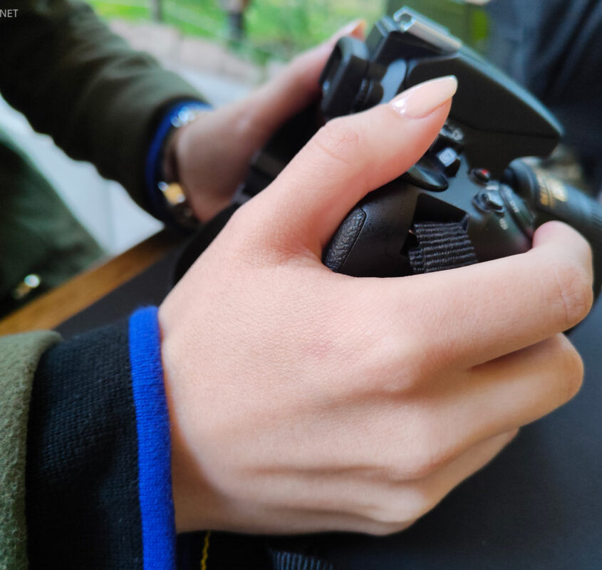 Photographer's hands with a photo camera