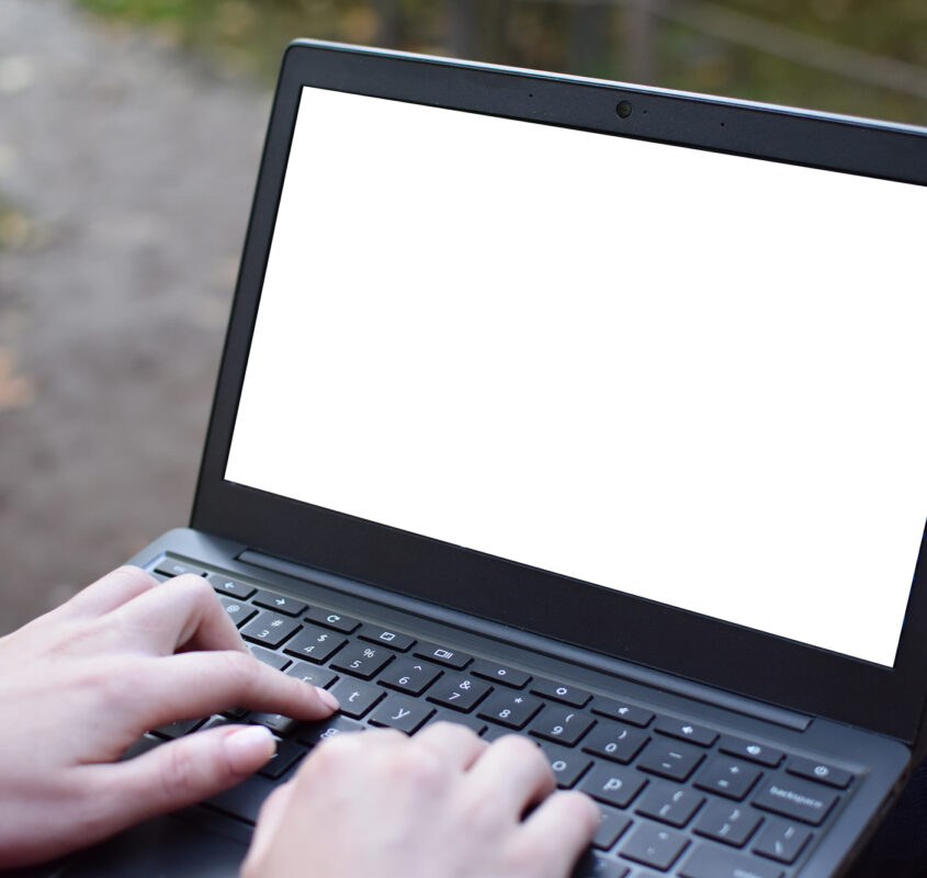 Female typing on the laptop with empty display