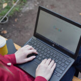 Female with laptop and coffee in the park